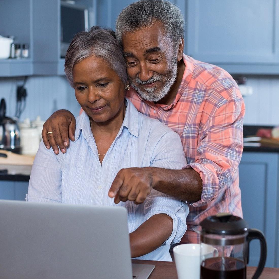 Retired couple using computer.